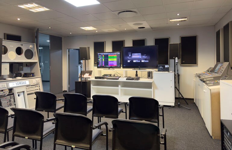 Johannesburg training facility with seating, Yamaha loudspeakers, displays, and audio equipment.