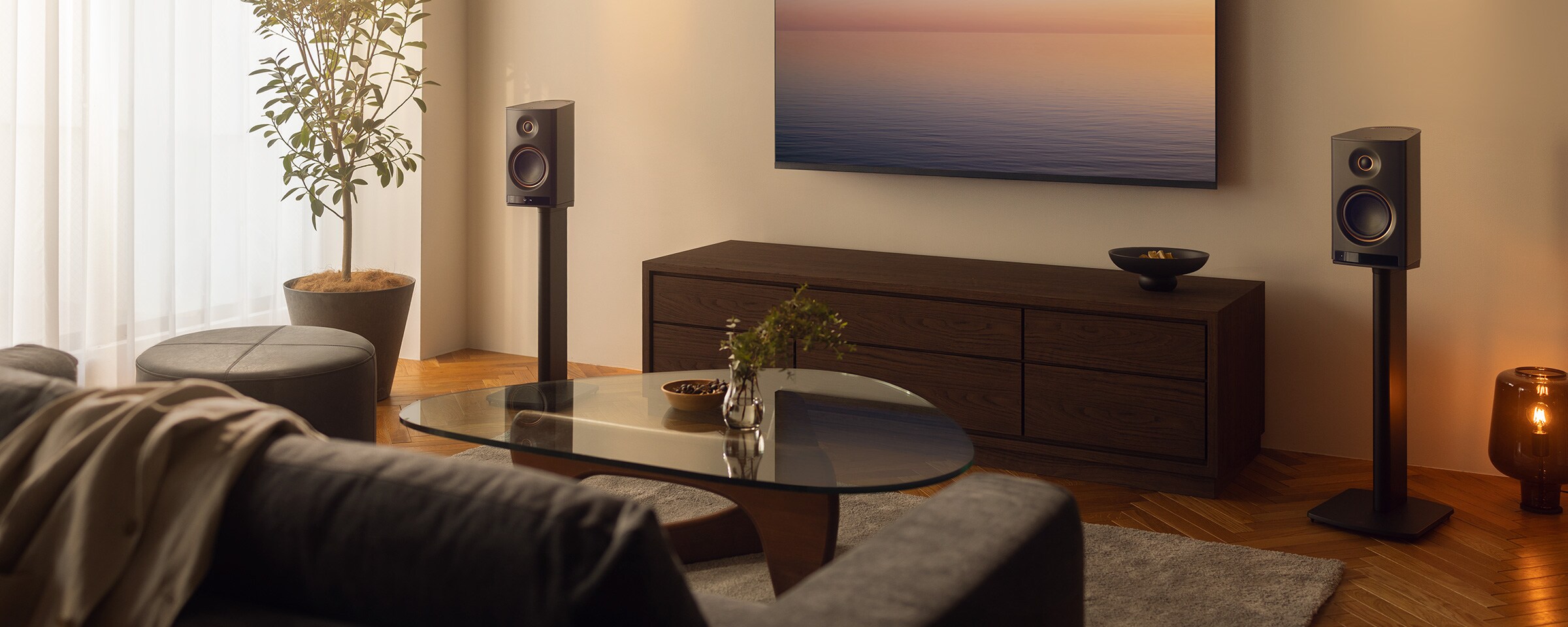Den trådlösa NX-70A Hi-Fi-högtalaren placerad bredvid en TV i ett modernt vardagsrum
