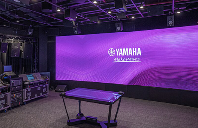 Bangkok training facility with Yamaha display wall, stage area, and professional audio equipment.
