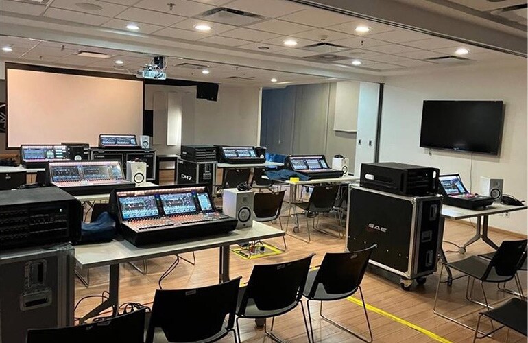 Mexico City training facility with digital mixing consoles, displays, and training room seating.