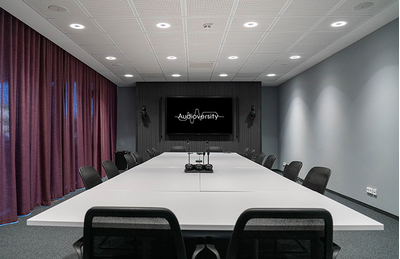 Rellingen training facility with tables, chairs, and presentation display.