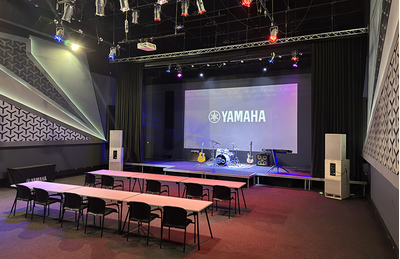 Johannesburg training facility auditorium with Yamaha display screen, stage area, and seating.