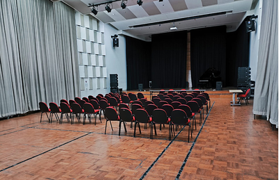 Jakarta training facility auditorium with stage, projection screen, and seating.
