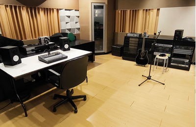 Jakarta training facility room with tables, seating, and audio training equipment.