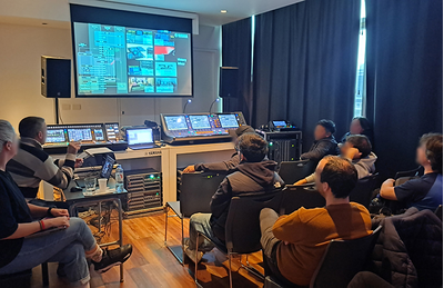 Buenos Aires training facility with attendees seated in an audio training room with projection and mixing equipment.