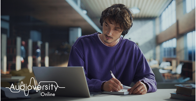 Audioversity Online logo and aura behind a man focused on an online training session.
