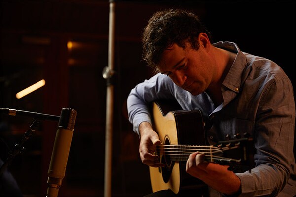 Singer-songwriter and guitarist Jordan Tice sitting and playing FG9